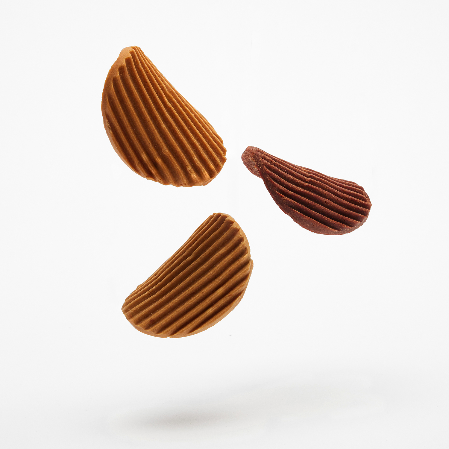 Triple Flavor Wavy Chips floating on grey background