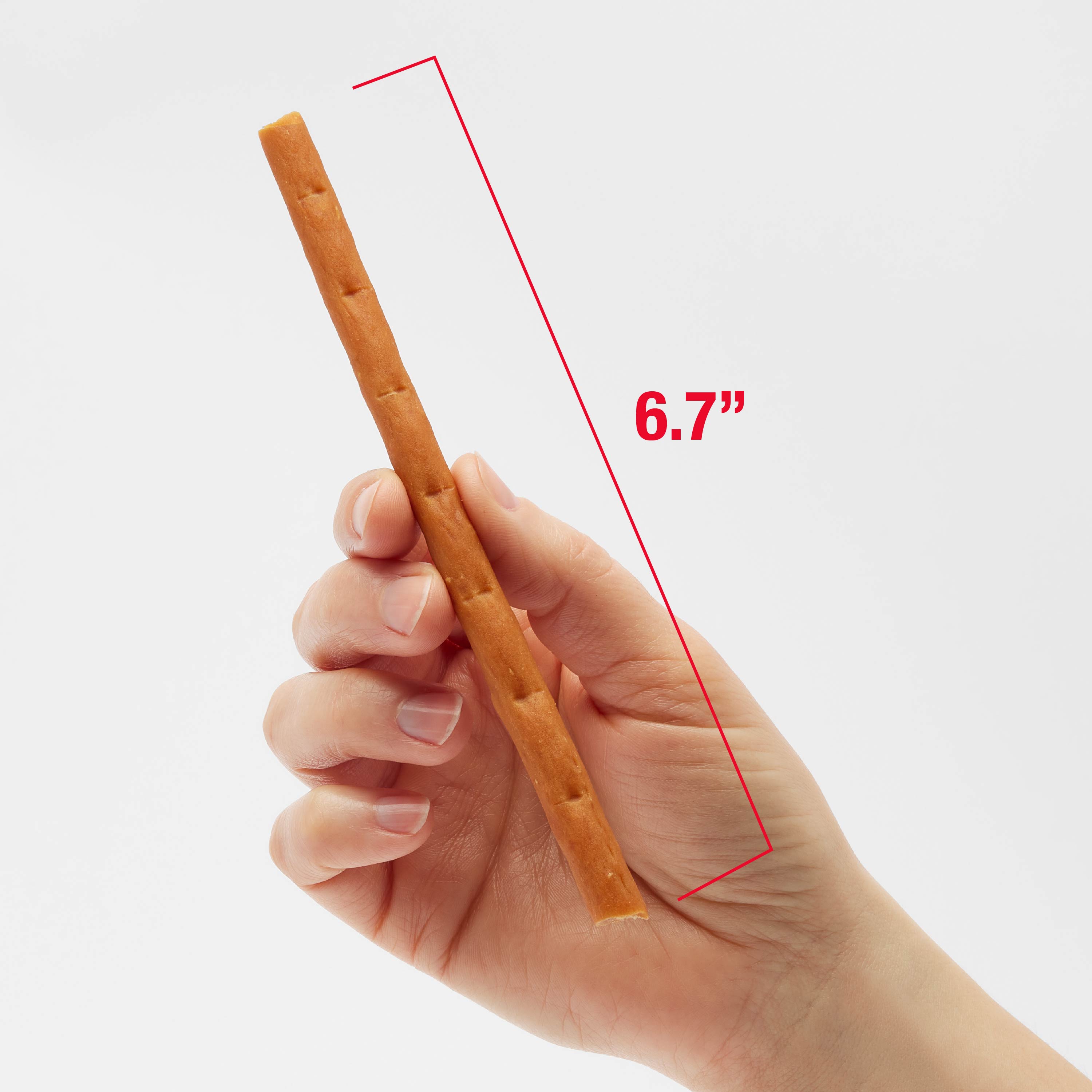 Woman holding a 6.7" long snap Ems treat